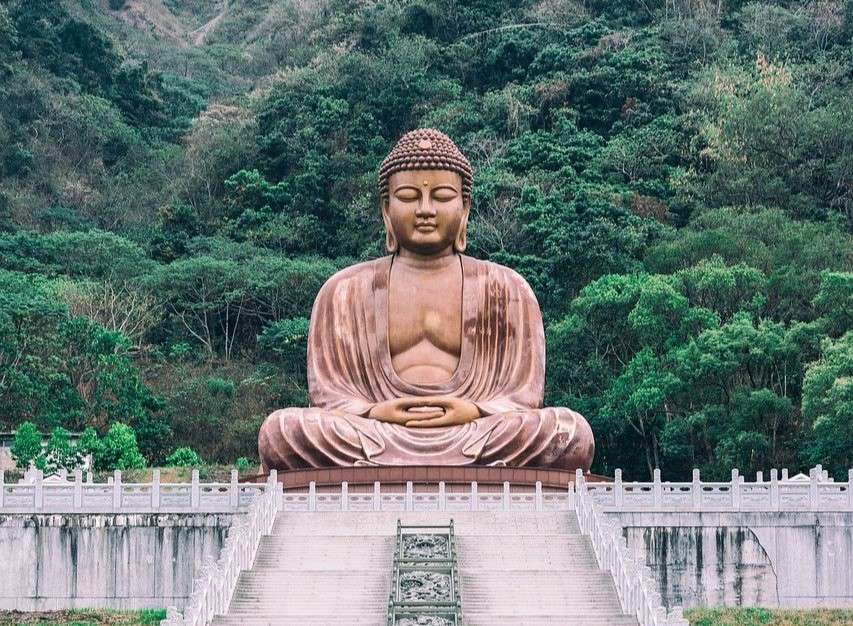 a large statue of a buddha, where you can travel. Is this from our world?