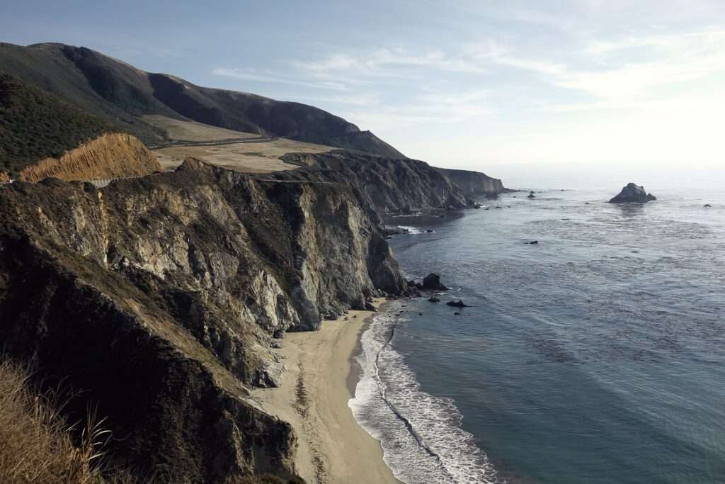 Travelgoals 2024 - A coast with cliffs and some sea and sandy beach