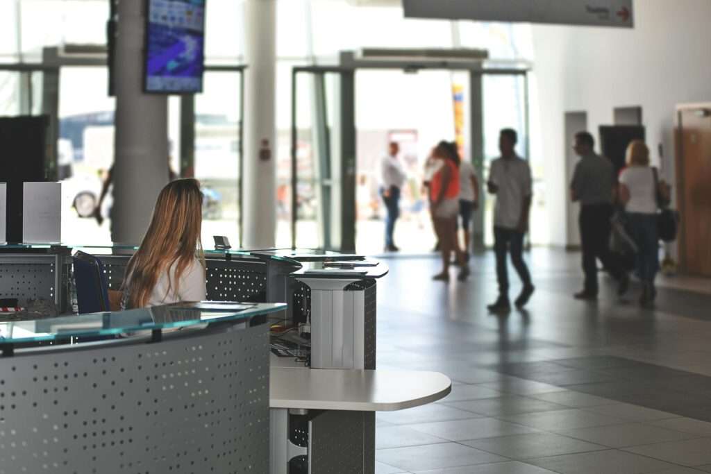 Dont vacation in England - Entrance area of a public facility. In the background blurred people walking around.