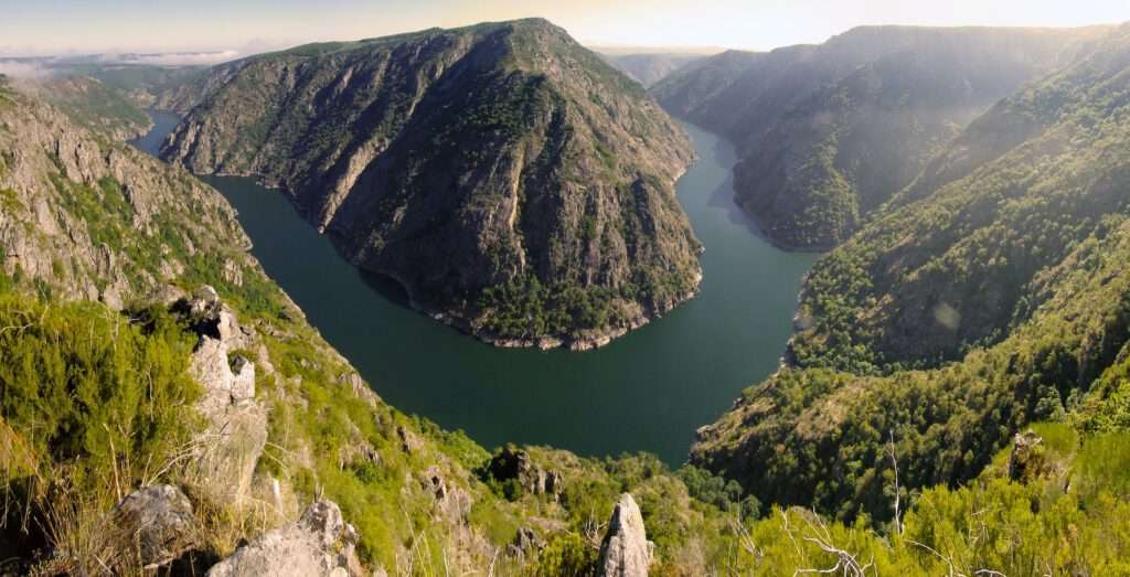 Travelgoals 2024 - Mountain range with valley where there is water.